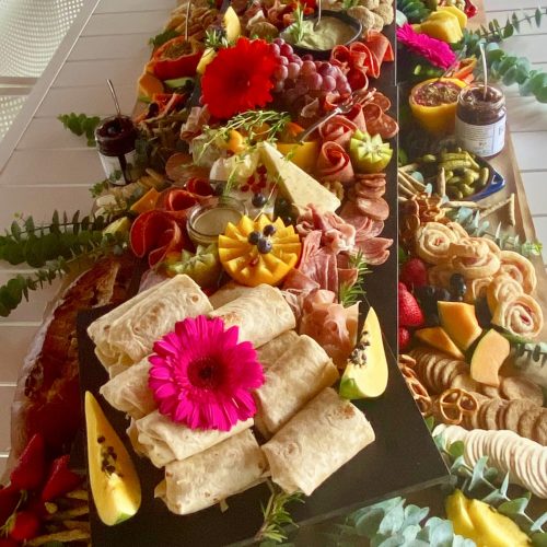 Luxury Grazing table filled with seasonal fruit, charcuteries, cheese, dips and everything delightful your guests will enjoy.